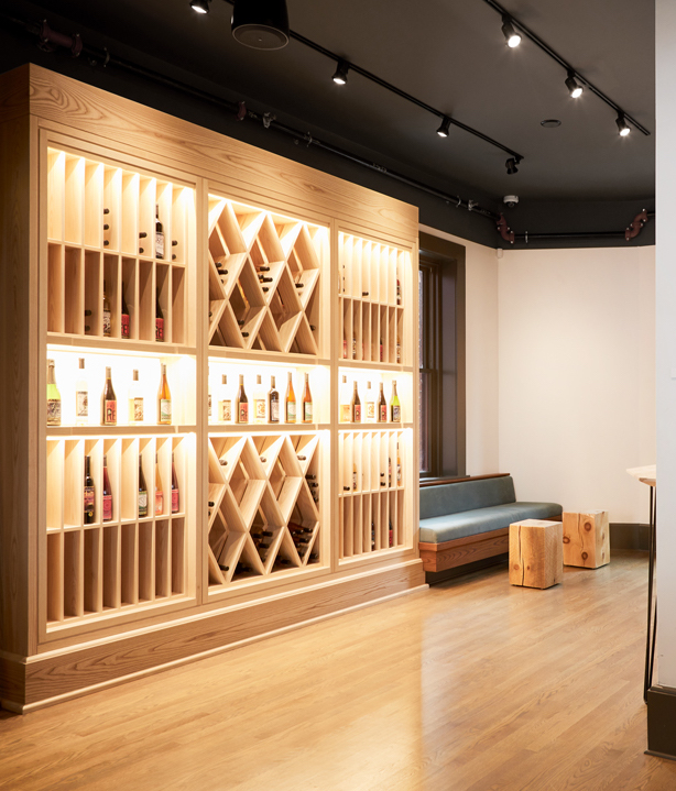 Interior view of custom built wine rack wall unit with vertical and cris crossing display areas
